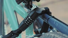Bike Secured To Outdoor Stand With Combination Lock	
