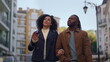 © stockbusters - African american couple walking city residential area discussing future plans.