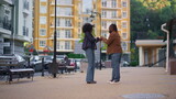 Fototapeta Na drzwi - Man apologize upset girl standing on city street. Relationship problems concept