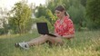 © Vlamin - Young woman stares intently at her laptop screen.