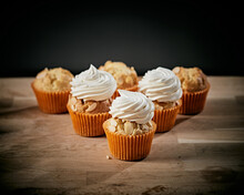 Cupcakes With Cream On Wood Background