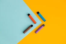 Modern Disposable Electronic Cigarettes On Color Background