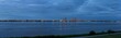 evening panorama of the Bremerhaven skyline seen from the opposite shore of the river Weser - translation: 
