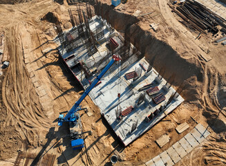 Poster - Сonstruction site, aerial view. Monolithic slab foundation and concrete pouring. Mobile auto Crane on formworks. Preparing Formwork for First Floor Slab on building сonstruction. .