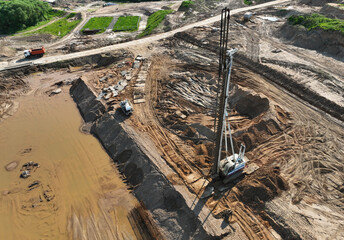 Wall Mural - Deep foundation machine. Drilling rig and Pile driver at construction site. Pile driven into ground by vibrating hydraulic hammer. Foundations construction work. Ground drilling and Piling Contractor.