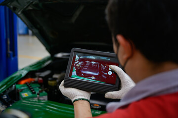 The mechanic works at the car service center. Use the scanner to diagnose vehicle problems using an electronic OBD and OBD2 device on your tablet.