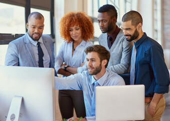 Sticker - All hands on deck. Shot of a group of businesspeople working together at a computer in the office.