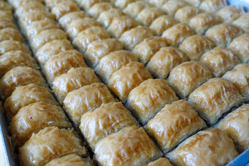 Wall Mural - Famous Turkish baklava dessert sliced in a baking tray, Gaziantep baklava,