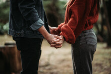 Couple Holding Hands In The Woods