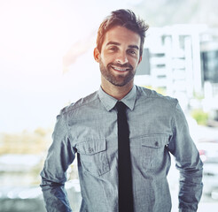 Wall Mural - Each day is a chance to grab a new opportunity. Portrait of a handsome young businessman standing in an office.