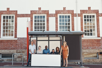 Aufkleber - Spread your message all across the city. Portrait of a group of people holding a blank sign while waiting at a bus stop in the city.