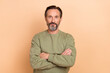 © deagreez - Portrait of attractive content man folded arms executive manager career isolated over beige pastel color background