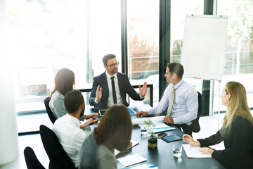 Poster - Working through the meeting agenda like pros. Shot of a team of executives having a formal meeting in a boardroom.