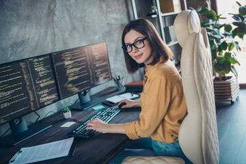 Profile side view portrait of attractive cheery girl expert developing operating system html css at workplace workstation indoors