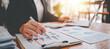 © Daenin - Portrait of a woman working on a tablet computer in a modern office. Make an account analysis report. real estate investment information financial and tax system concepts
