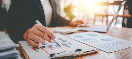 Portrait of a woman working on a tablet computer in a modern office. Make an account analysis report. real estate investment information financial and tax system concepts