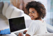 © Mapodile M./peopleimages.com - This site is awesome. Over the shoulder shot of a young woman using a laptop at home.