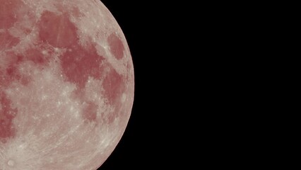 full red moon moves fast at night sky. sharp footage of full moon with telephoto lens close-up. pink