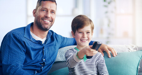 Wall Mural - were going to be couch potatoes today. shot of a cheerful father and son relaxing on a couch and spe