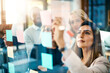 © Koegelenberg/peopleimages.com - Planning is always a crucial step in success. Shot of a group of businesswomen arranging sticky notes on a glass wall in a modern office.