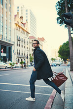 Hes A Man On A Mission. Shot Of A Stylish Man Crossing A City Street.