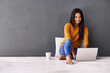 © Arcurs Co-op/peopleimages.com - Laid-back and happy on the floor. Shot of an attractive young woman using a laptop while sitting on the floor.