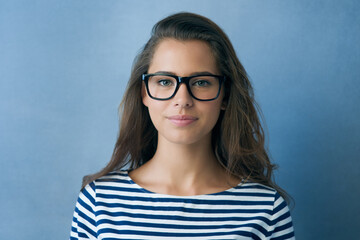 Canvas Print - See the good. Studio shot of an attractive young woman wearing glasses.