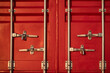 © CrunchyBeans - Red metal container door background. Beautiful cargo in sunshine on summer day. Logistic and transportation business. Shiny details and padlocks. Creative backdrop for design. Close up, copy space