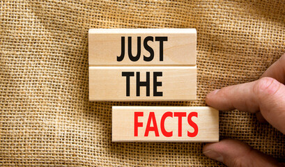 Just the facts symbol. Concept words Just the facts on wooden blocks on a beautiful canvas table canvas background. Businessman hand. Business and just the facts concept. Copy space.