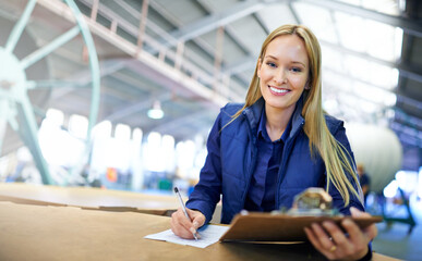 Aufkleber - The warehouse couldnt be running any smoother. Portrait of a smiling manager reading paperwork while standing on the factory floor.