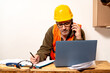 © HC FOTOSTUDIO - Contractor talking on cell phone while checking laptop and taking notes of what he talks about in the work office. Work organization concept, telecommunication, modern work.