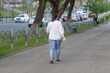 © Александр Поташев - A very fat woman walks down a city street in summer.