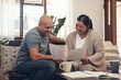 © N Felix/peopleimages.com - Youd be smiling too if you saved like they did. Shot of a young couple going over paperwork at home.