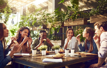 Poster - Catching up on statistics while enjoying a good bite. Cropped shot of a group of creative workers having a meeting over lunch in a cafe.