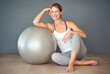 © Cecilie Skjold Wackerhausen/peopleimages.com - Just roll with it. Shot of a sporty young woman sitting next to her fitness ball.