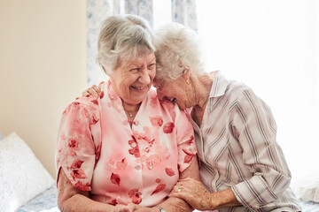 nothing inspires happiness like a good old friend. shot of two happy elderly women embracing each ot