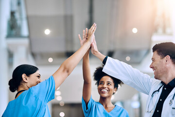 Aufkleber - We did it together. Shot of a diverse team of doctors giving each other a high five in a hospital.