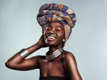 Nothing Tops Off Your Look Like A Stylish Head Wrap. Studio Shot Of A Beautiful Young Woman Wearing A Traditional African Head Wrap Against A Grey Background.