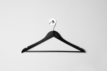 Wall Mural - Empty black clothes hanger on white wall