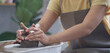 © wattana - Young craftswoman working on pottery wheel in handmade ceramics workshop. Creative activities, pottery, ceramics art concept.