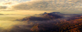 Fototapeta  - Aerial view panorama Morning scenic on high mountains with electricity pylon Pang Puay, Mae Moh, Lampang, Thailand. Beautiful morning with golden sunrise and fog flowing.