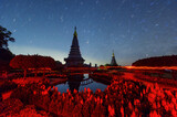 Fototapeta  - Star trails moving over a sacred temple at Doi Inthanon National Park, Chiang Mai, Thailand. 