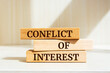 © Uuganbayar - Wooden blocks with words 'CONFLICT OF INTEREST'. Business concept