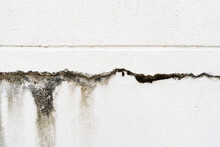 House Broken. Concrete Crack. Water Damage Building Interior. Large Crack White Concrete Wall