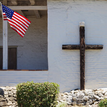 US Flag And A Christian Cross On An Historic Mission Church