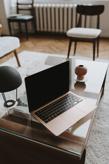 Laptop computer with blank screen on table. Aesthetic influencer styled workspace interior design template with mockup copy space