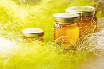 Wall Mural - Honey in glass jars with flowers background.