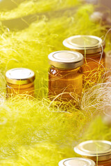 Wall Mural - Natural honey in various jars on a wooden shelf, souvenir village market.