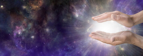 Wall Mural - heavenly life force concept sky banner - male cupped hands with bright white light energy radiating 
