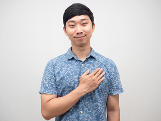 Positive young man blue shirt touch his chest heart happy emotion gentle